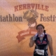 A record number of triathletes registered for the 2019 Kerrville Triathlon, including this female sprint finisher posting in front of the Kerrville Tri sign.