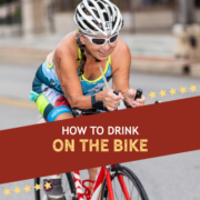Female cyclist rides on the bike course during the Kerrville Triathlon. Text on design reads How to Drink on the Bike. Learn more about hydrating while cycling at https://kerrvilletri.com/2020/09/hydrating-while-cycling/