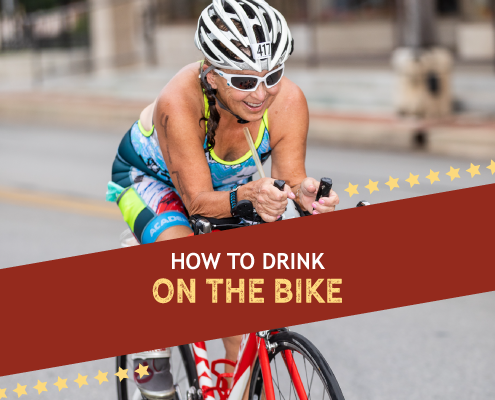 Female cyclist rides on the bike course during the Kerrville Triathlon. Text on design reads How to Drink on the Bike. Learn more about hydrating while cycling at https://kerrvilletri.com/2020/09/hydrating-while-cycling/