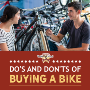 A female customer speaks with a bike shop sales representative in front of a row of bikes. Text on design reads Dos and Don'ts of Bike Buying. Learn more at https://kerrvilletri.com/2020/10/bike-buying/