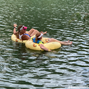 triathlon finishers float in custom Kerrville Tri Floats in the Guadalupe river after completing the triathlon