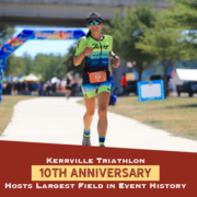 Female runner has a huge smile during the run portion of the 2021 Kerrville Tri. Text on design reads Kerrville Triathlon 10th Anniversary Hosts Largest Field in Event History. Read more at http://kvy.b5e.myftpupload.com/2021/09/largest-field-in-event-history/